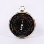 BAROMÈTRE EN PIERRE D'OBSIDIENNE<br>Ø12CM - COLLABORATION